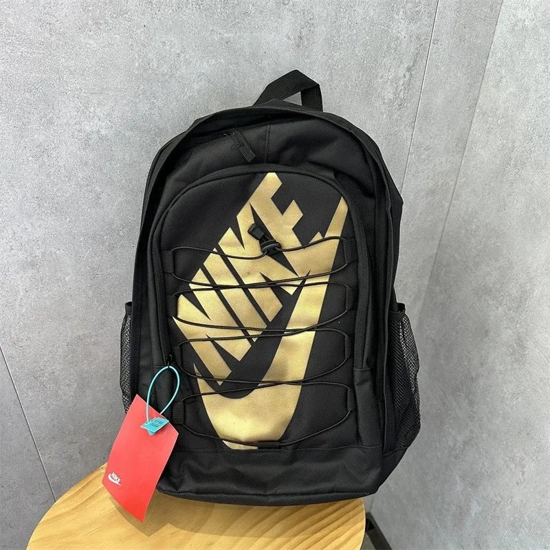 Nike Black and Gold Backpack with Swoosh Design